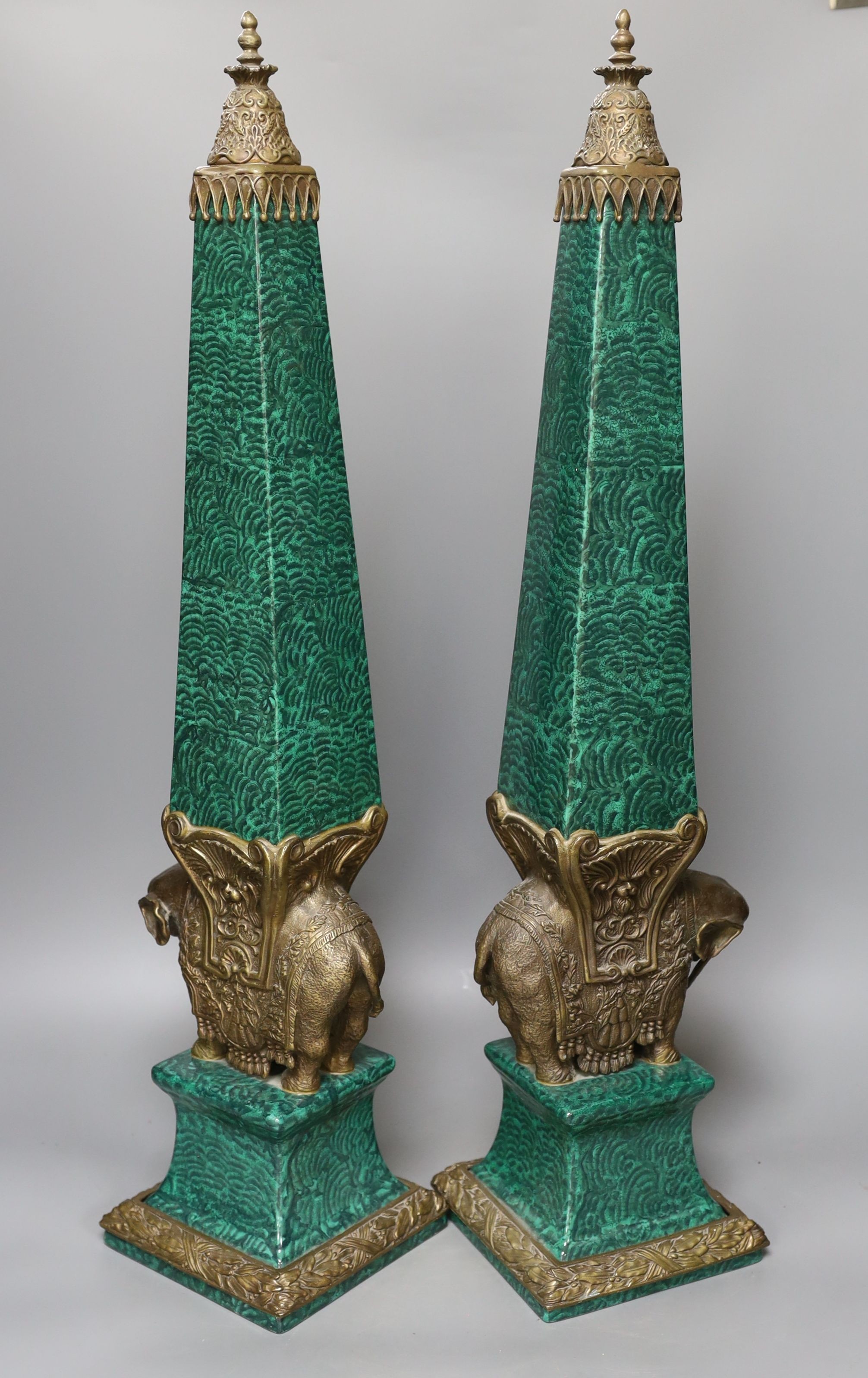 A decorative pair of faux malachite ‘elephant’ obelisks 65cm tall